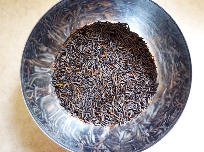 Uncooked wild rice in bowl for Yam and Wild Rice Salad with Lime-Chili Vinaigrette recipe