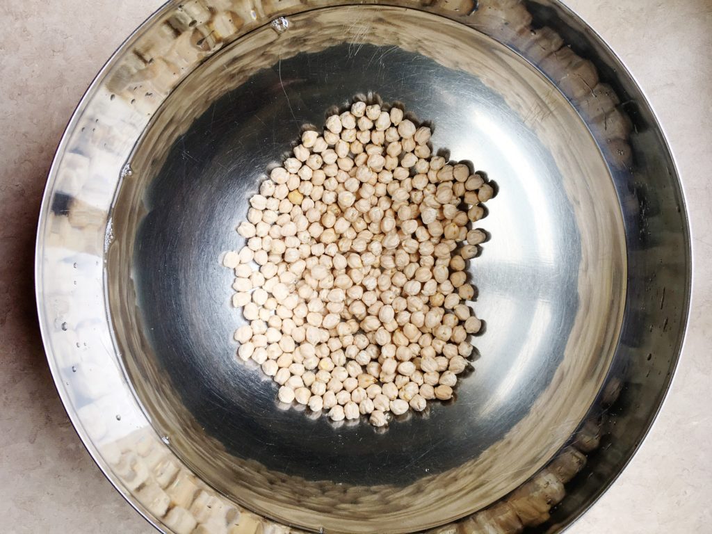 Chickpeas soaking in water in stainless steel IKEA bowl