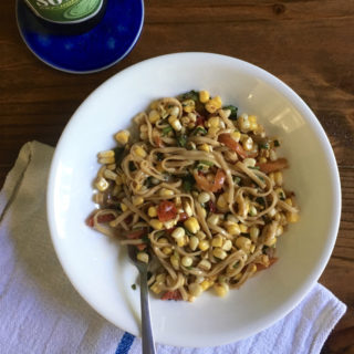 Noodle salad with sautéed peppers, corn, and sesame marinade with beer