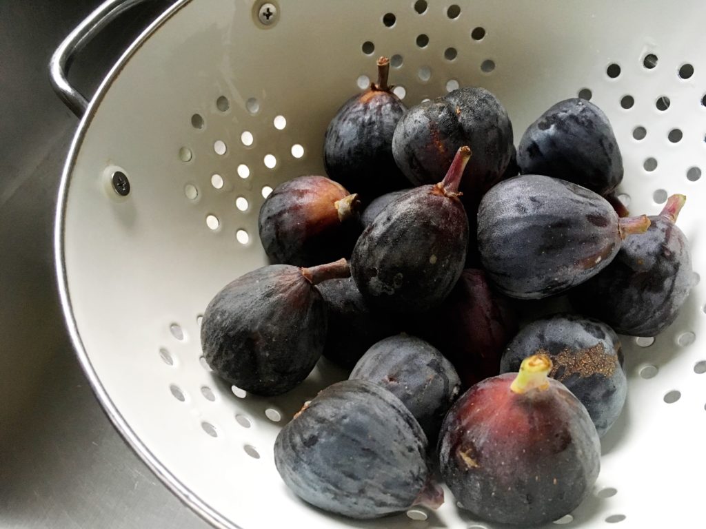 Fresh figs in white colander