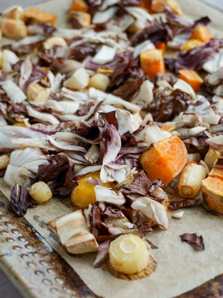 Roasted root vegetables and radicchio on baking pan
