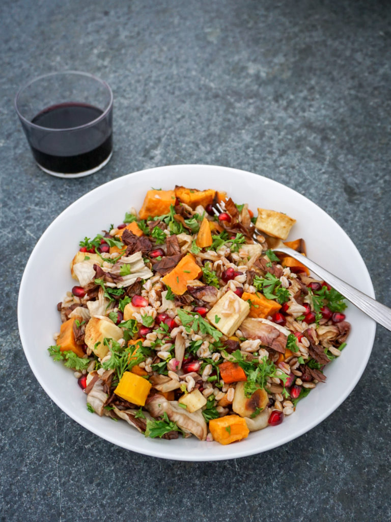 Farro Salad with Radicchio, Root Vegetables, and Pomegranate with glass of wine on grey background from David Lebovitz My Paris Kitchen
