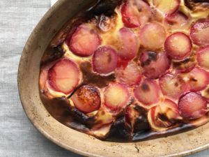 Plum clafoutis in rustic French gratin dish