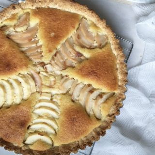 Pear and Almond Tart on cooling rack and white background