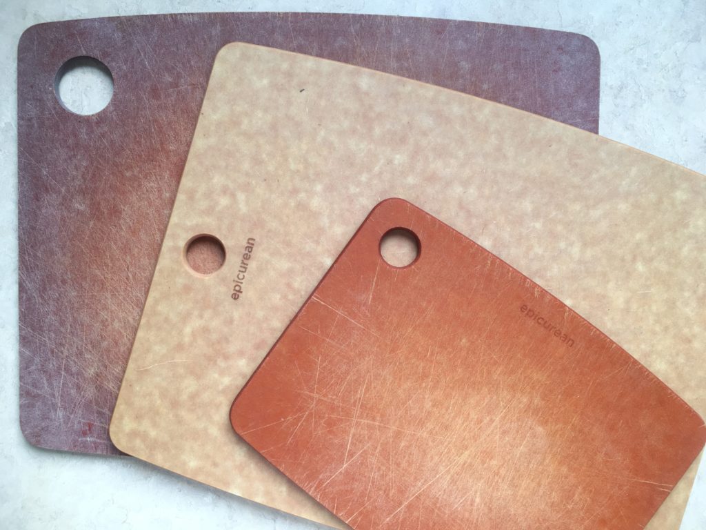 Three wood composite epicurean cutting boards in various shades of brown