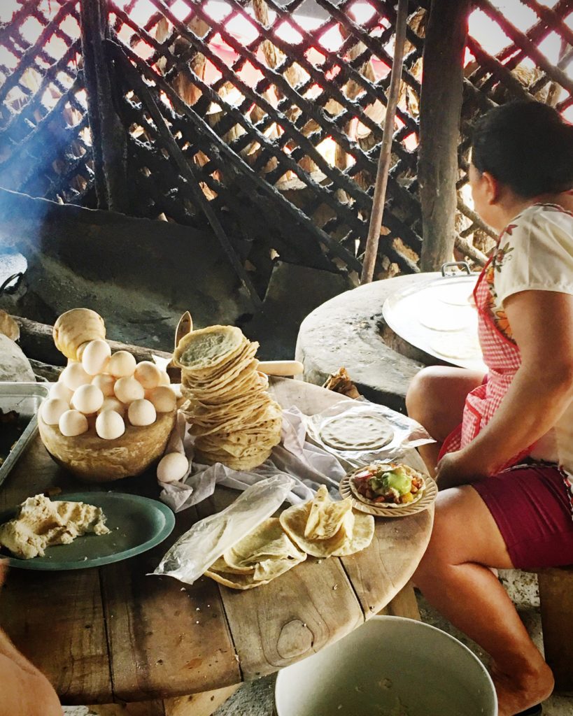 Woman cooking tortillas with egg and hot griddle at La Tia de Kaua