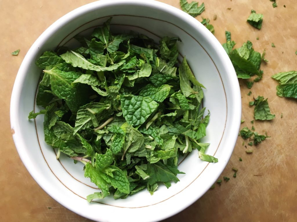 Chopped mint in Puglia ceramic bowl on Epicurean cutting board