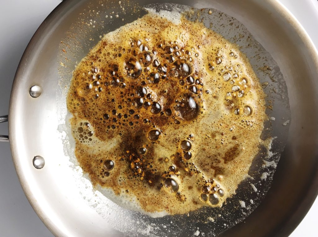 Butter, spices, and lemon juice in frying pan