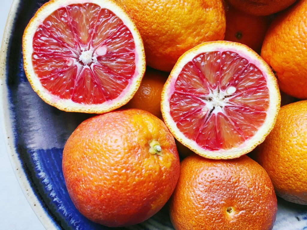 Blood oranges in blue ceramic bowl from Provence