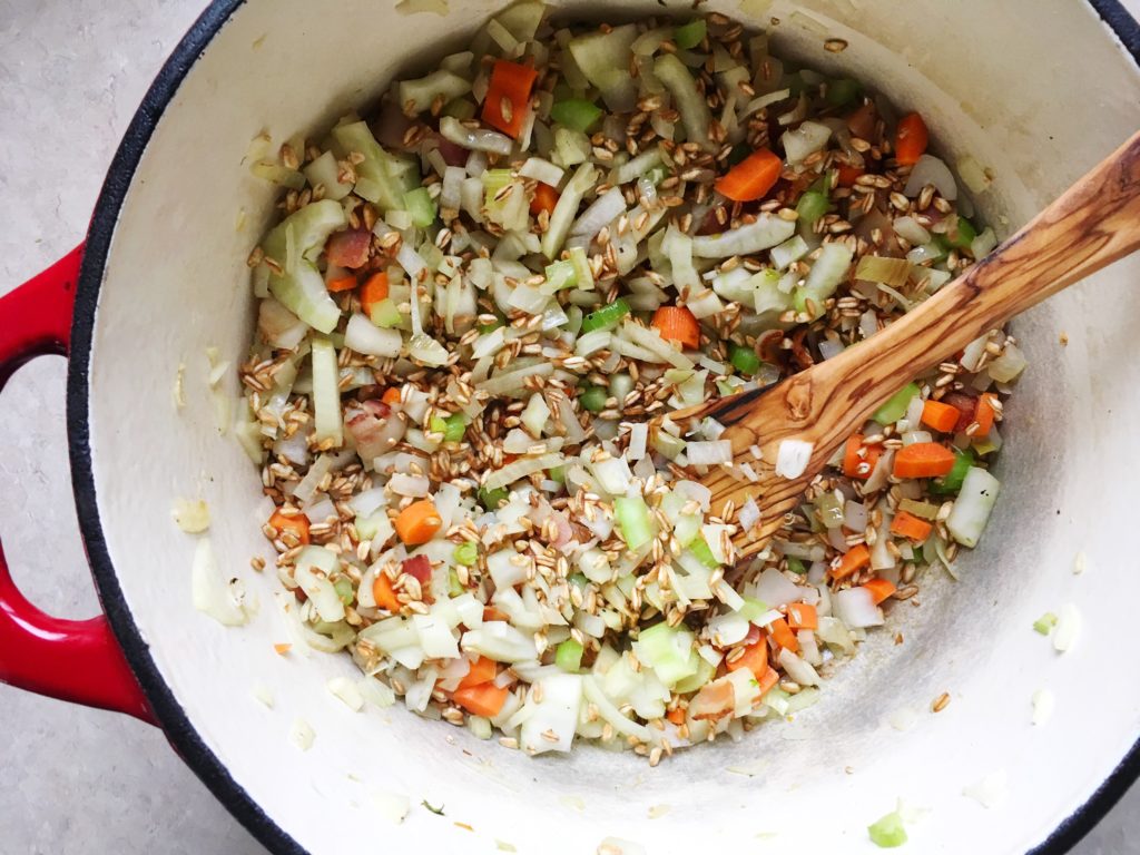Farro, fennel, carrots, celery, onion, and garlic sauteeing in Dutch oven