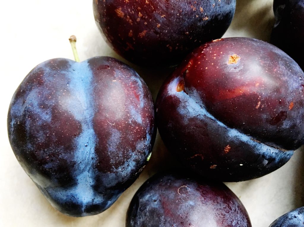 Four black plums from the farmers market