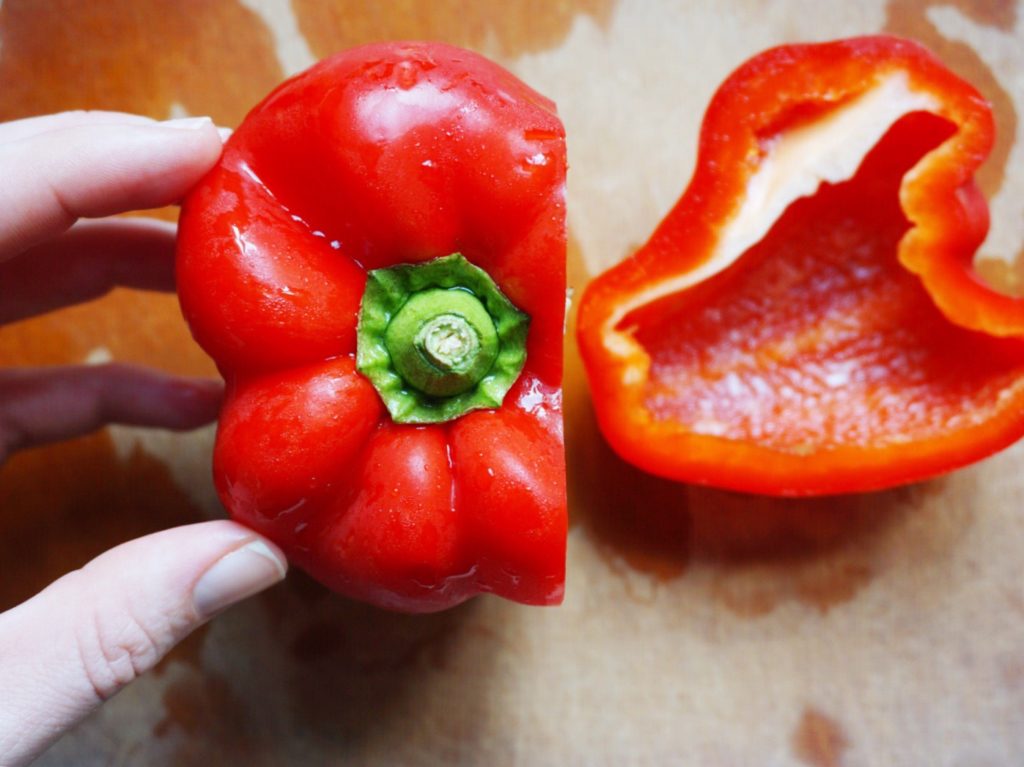 Red bell pepper with one cut through it