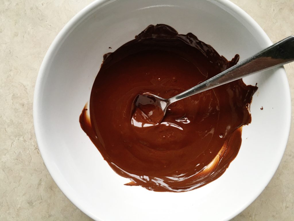 Melted chocolate in white bowl