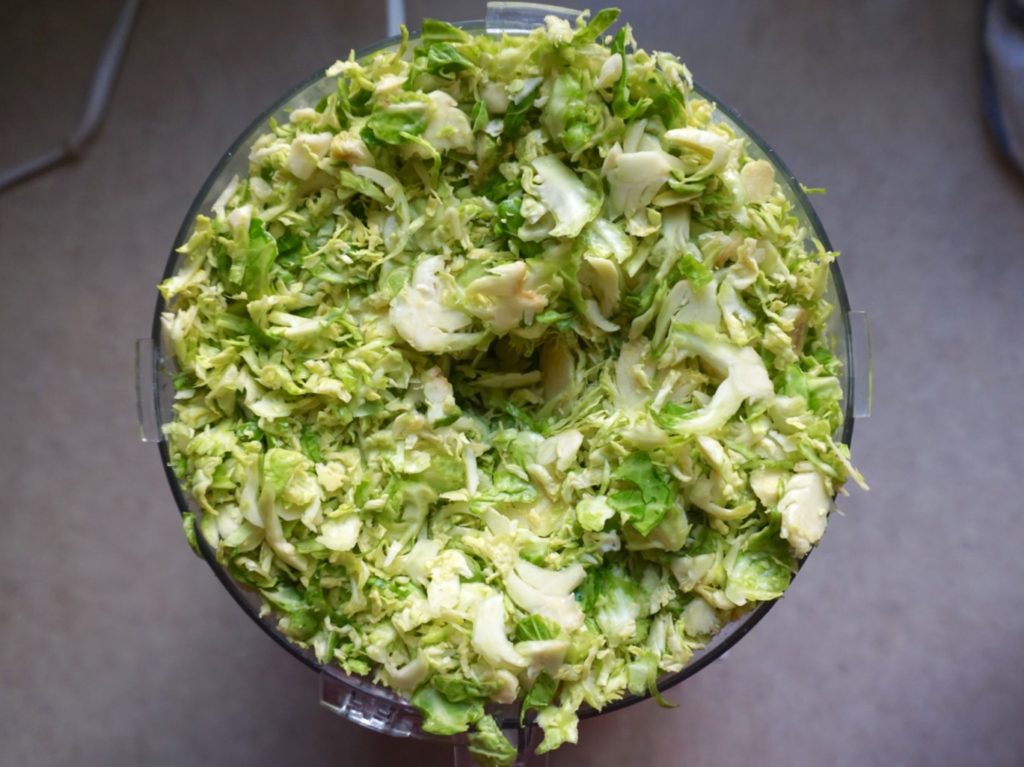 Shredded Brussels sprouts in food processor using slicing attachment