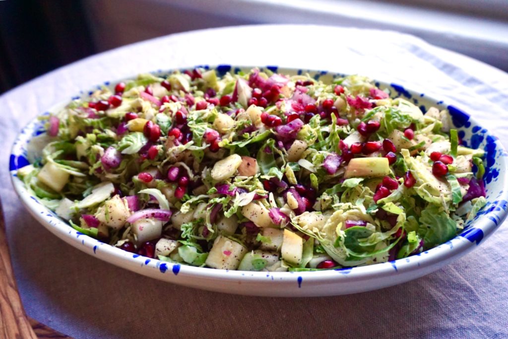 Brussels sprouts, apple, and pomegranate salad in Puglia ceramic dish