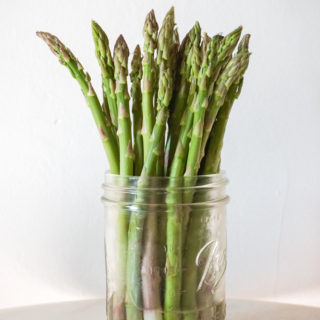 asparagus stored upright in water in mason jar