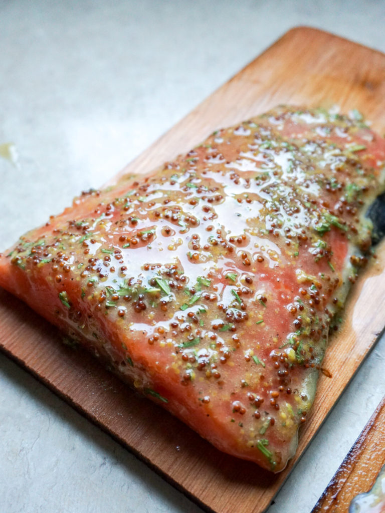 Marinaded wild salmon on cedar plank ready to grill