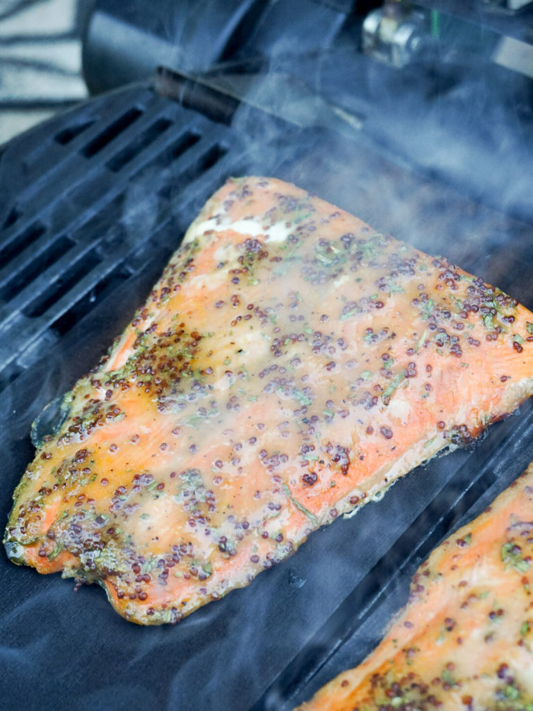 Rosemary, mustard, and honey marinaded salmon on cedar plank on grill