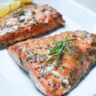 Cedar Grilled Salmon with Rosemary-Mustard Glaze on white plate