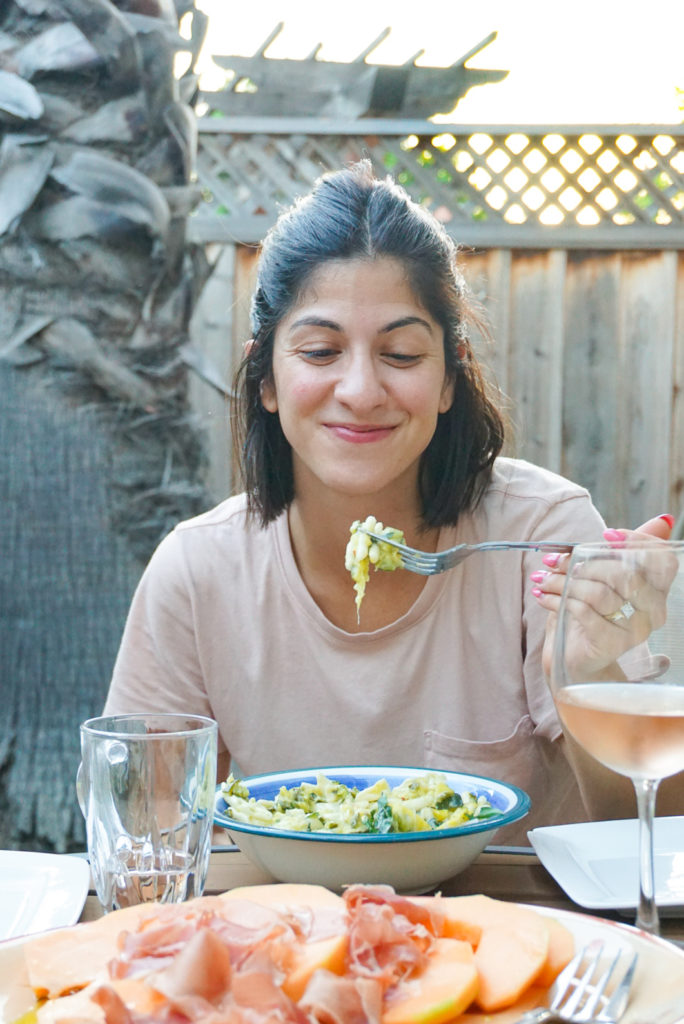 Parinaz eating summer squash and basil pasta