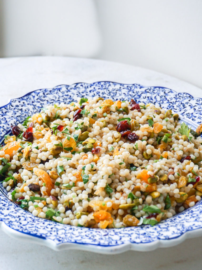 Israeli Couscous with Preserved Lemons, Pistachios, and Dried Fruit in blue Iznik pottery