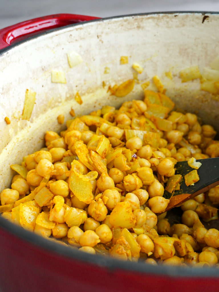 Yellow chickpeas in red Dutch oven