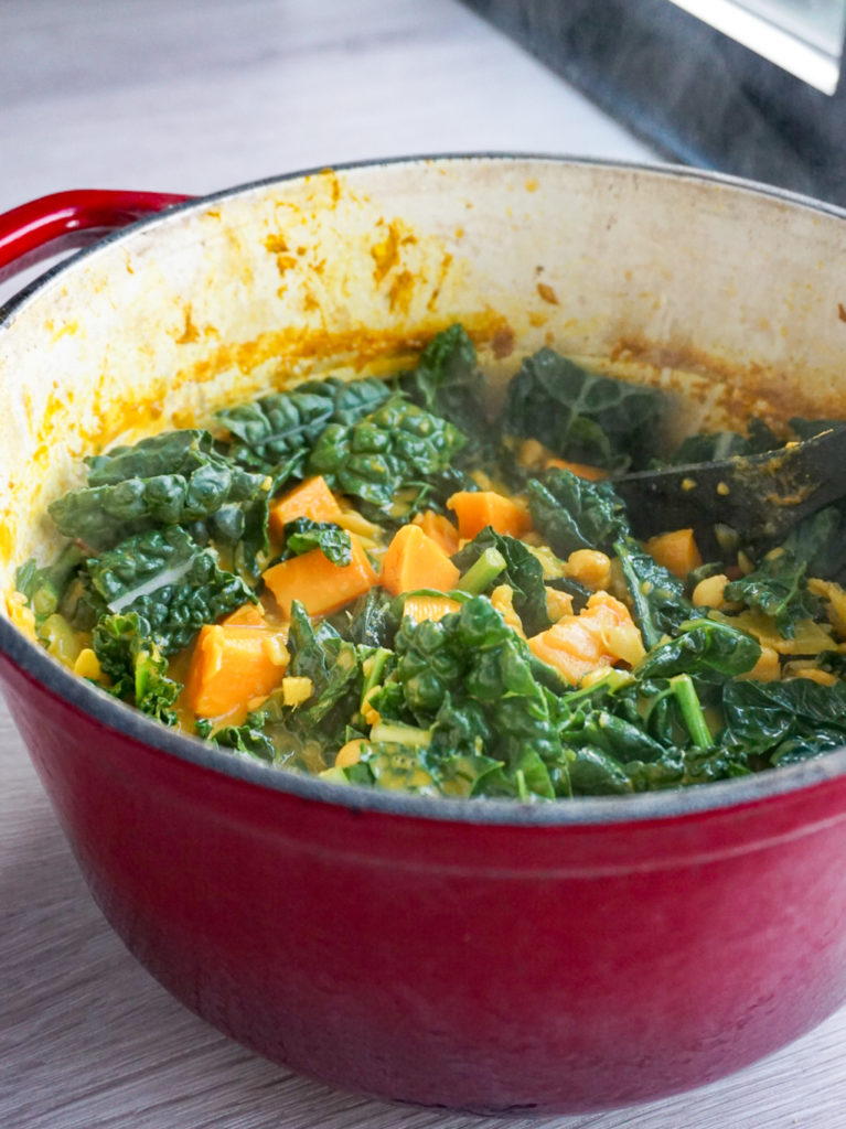 Spiced Chickpea, Sweet Potato, and Coconut Stew with Cumin and Turmeric in red Dutch oven