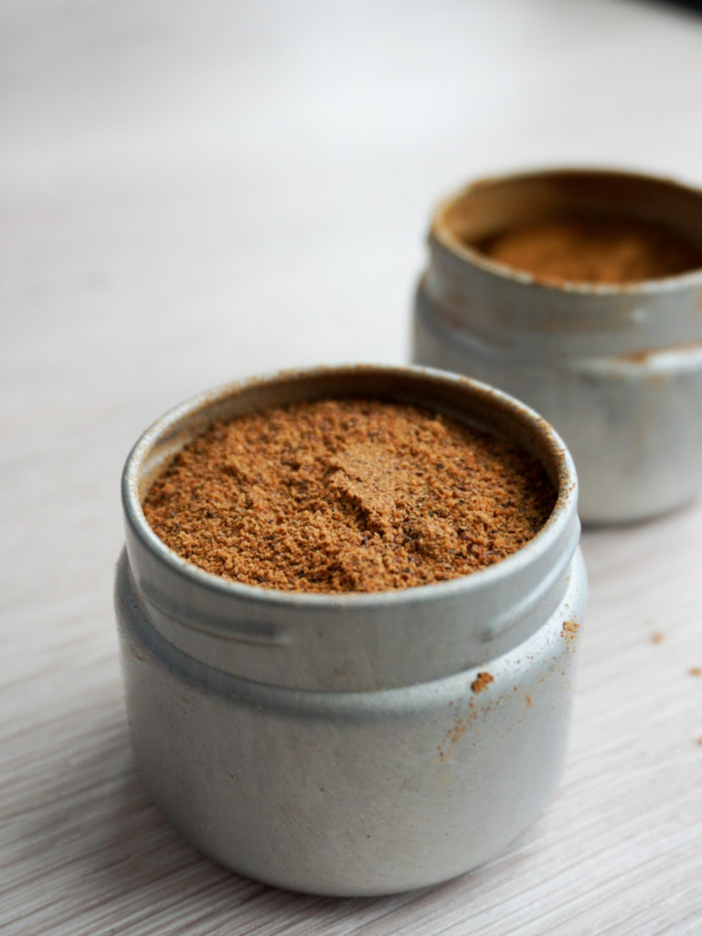 Open containers of nutmeg and cinnamon