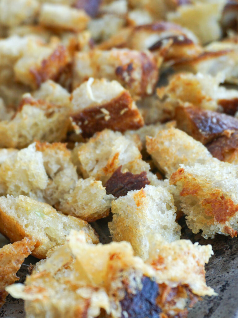 toasted parmesan croutons on baking sheet