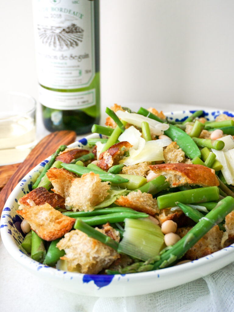 Spring vegetable panzanella with asparagus in blue platter