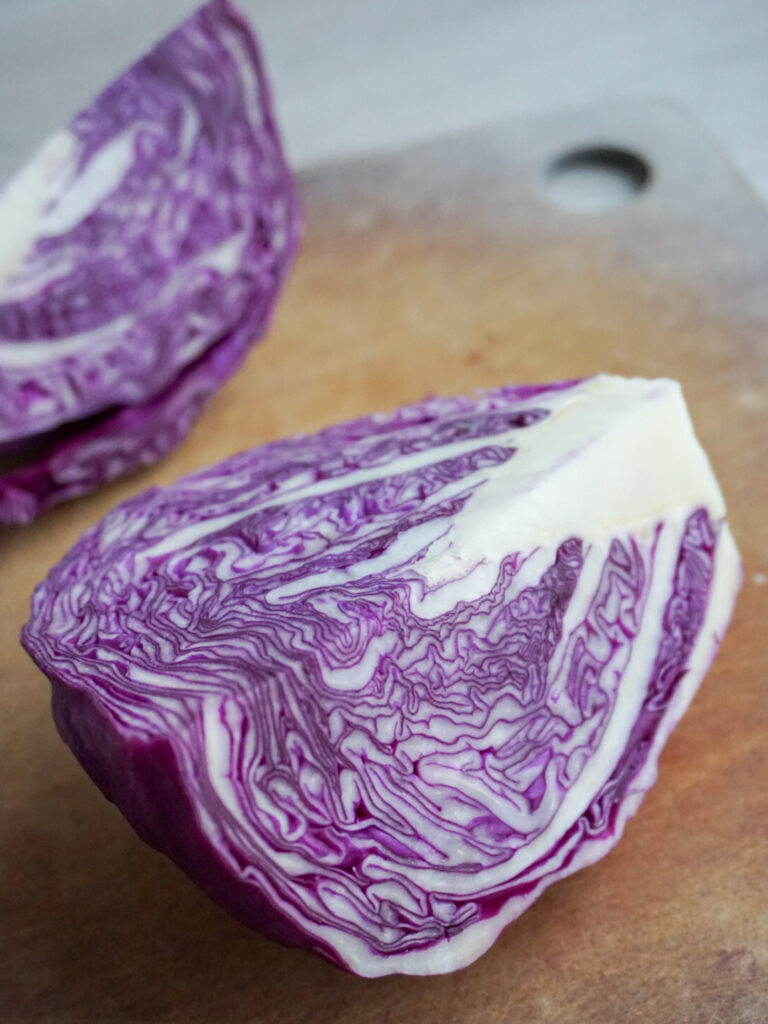 wedge of red cabbage on cutting board