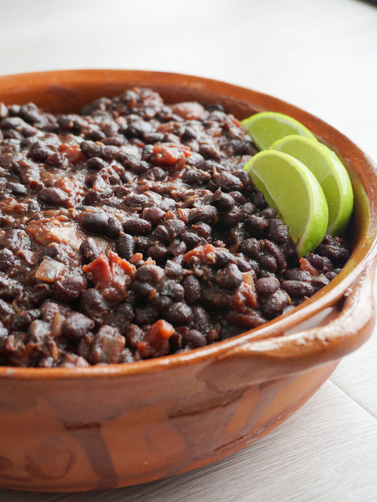 Smoky baked beans in dish with lime