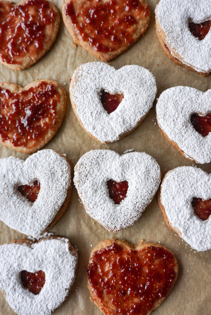 Pecan and raspberry liner cookies on baking paper